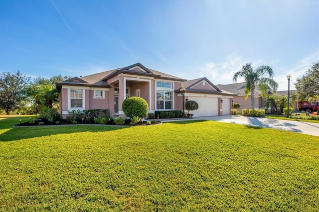 view of front of house featuring a garage and a front lawn