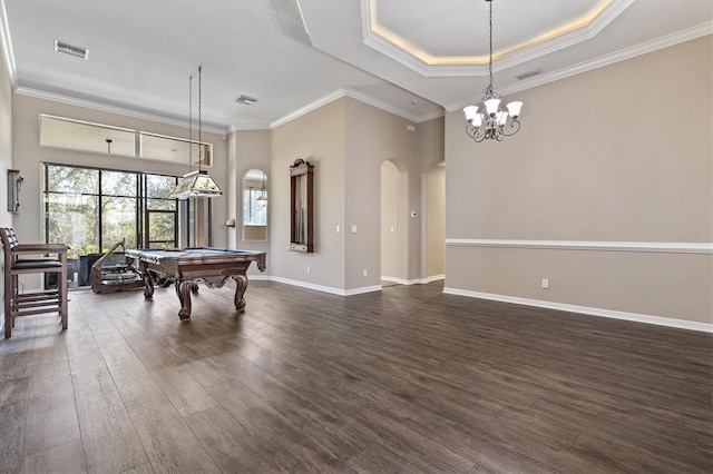 rec room with dark wood-type flooring, crown molding, billiards, a tray ceiling, and a chandelier