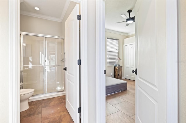 bathroom featuring tile patterned floors, an enclosed shower, ceiling fan, crown molding, and toilet