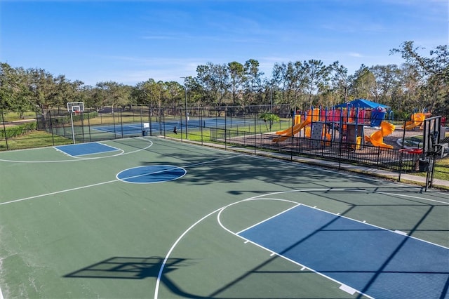 view of basketball court with a playground and tennis court