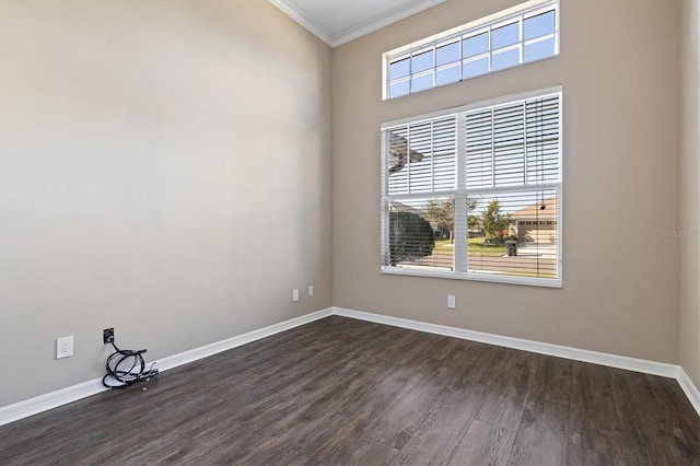 unfurnished room with ornamental molding and dark wood-type flooring