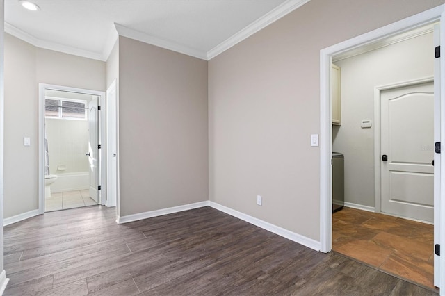 spare room with dark hardwood / wood-style flooring and crown molding