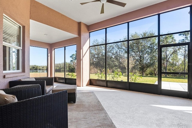 sunroom / solarium featuring ceiling fan