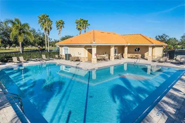 view of swimming pool featuring a patio area and central AC