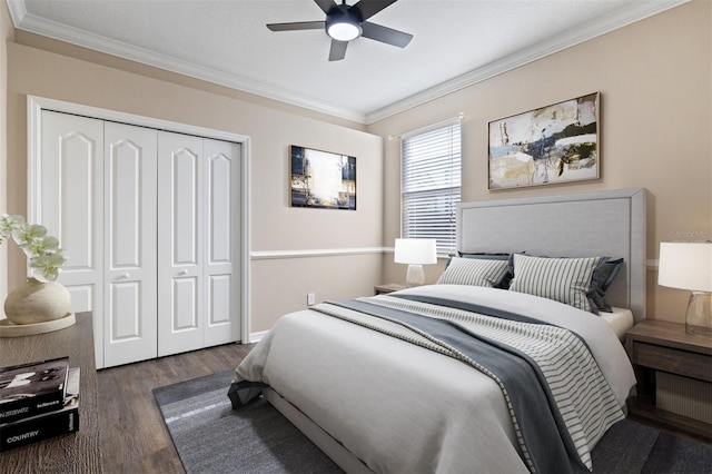 bedroom featuring crown molding, ceiling fan, a closet, and dark wood-type flooring