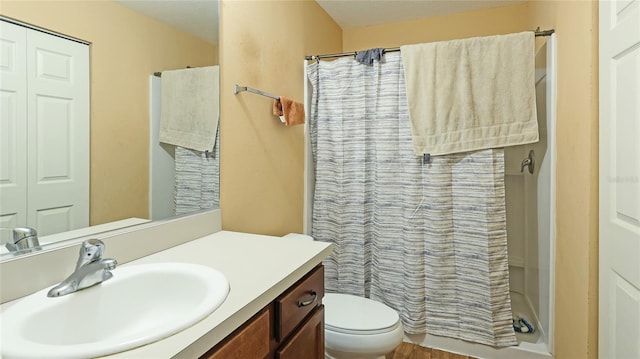 bathroom with curtained shower, vanity, hardwood / wood-style flooring, and toilet