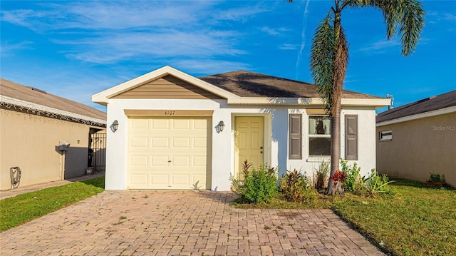 4107 11th St E, Bradenton, FL 34208 - view of front of house featuring stucco siding, decorative driveway, and a garage