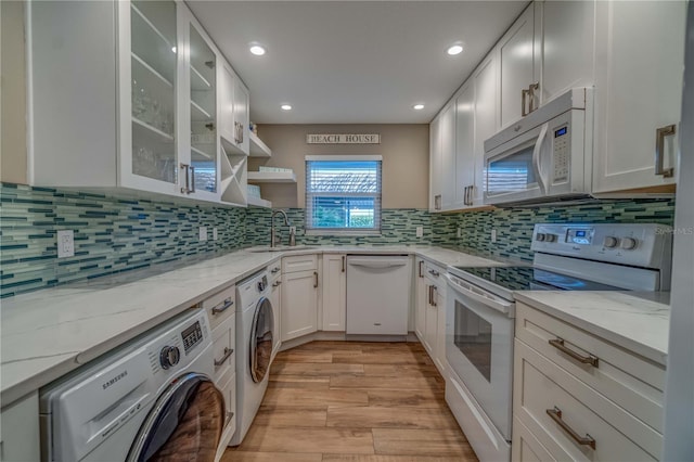 kitchen featuring light stone countertops, white cabinetry, sink, light hardwood / wood-style floors, and white appliances