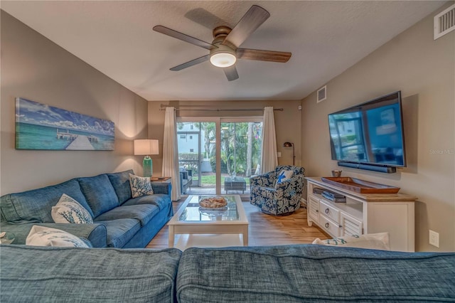 living room with light hardwood / wood-style floors and ceiling fan