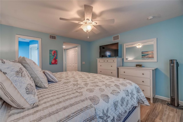 bedroom featuring ceiling fan, a closet, and light wood-type flooring