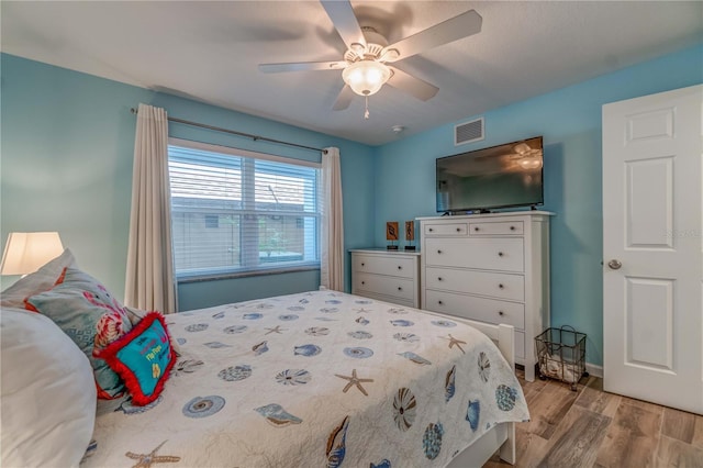 bedroom with ceiling fan and light wood-type flooring