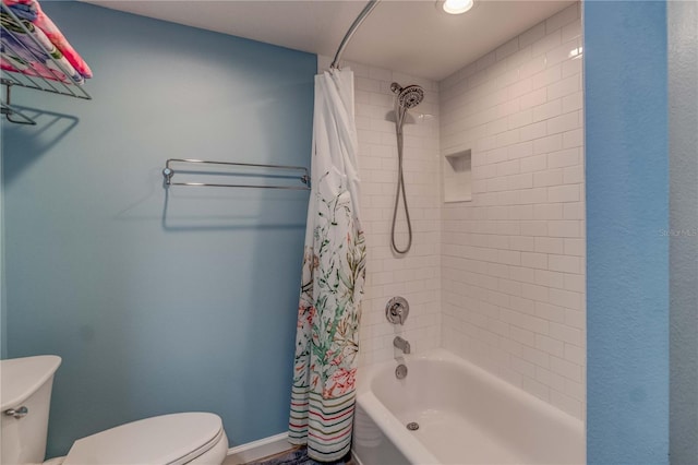 bathroom with shower / bath combo with shower curtain and toilet