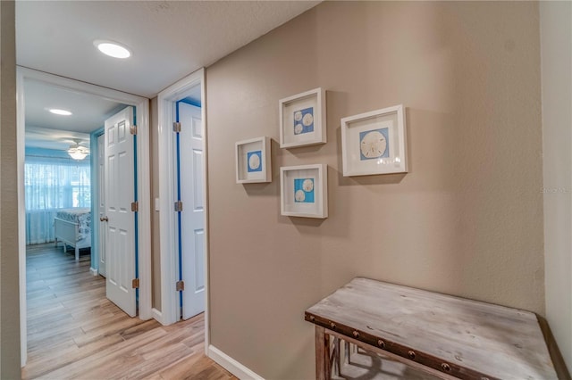 corridor with light hardwood / wood-style flooring