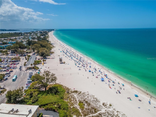 birds eye view of property with a water view and a beach view