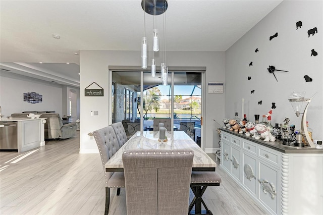 dining space with light hardwood / wood-style floors