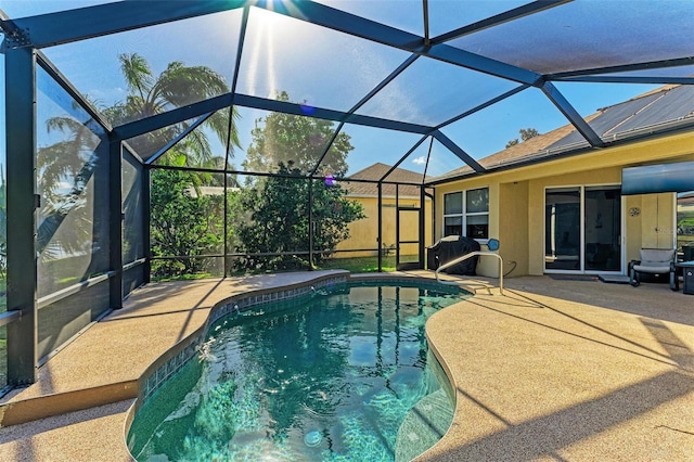 view of swimming pool with a patio and glass enclosure