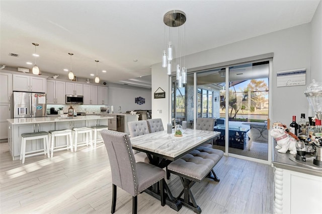 dining room with recessed lighting, visible vents, and light wood-style floors