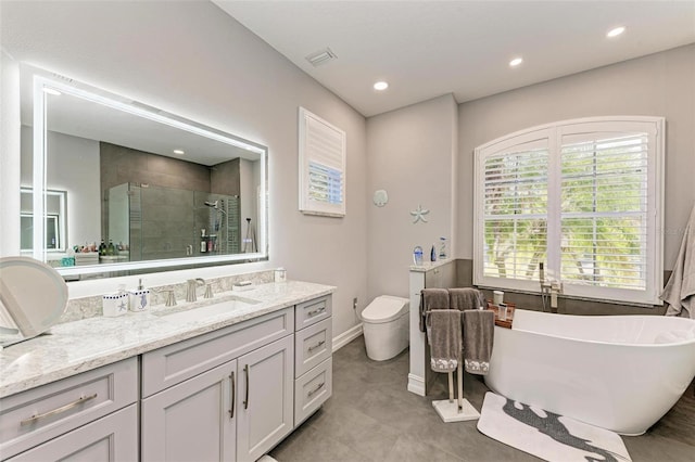full bath featuring vanity, a freestanding tub, recessed lighting, a shower stall, and visible vents