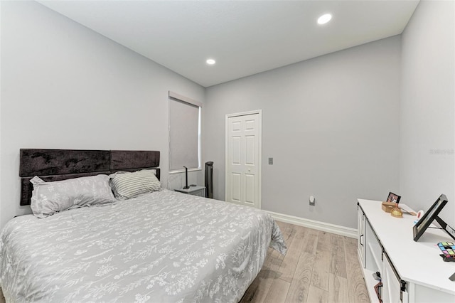 bedroom with baseboards, light wood-style floors, and recessed lighting