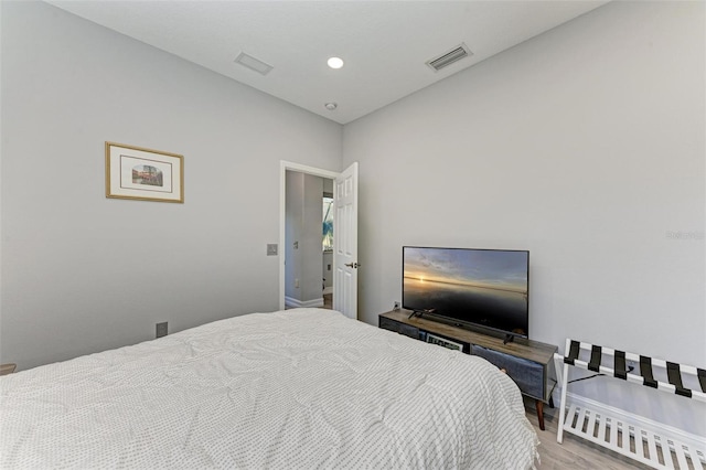 bedroom with baseboards, visible vents, wood finished floors, and recessed lighting