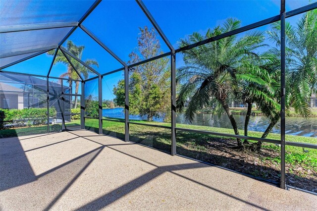 unfurnished sunroom featuring a water view
