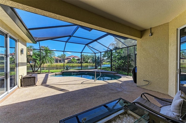 pool featuring glass enclosure and a patio area