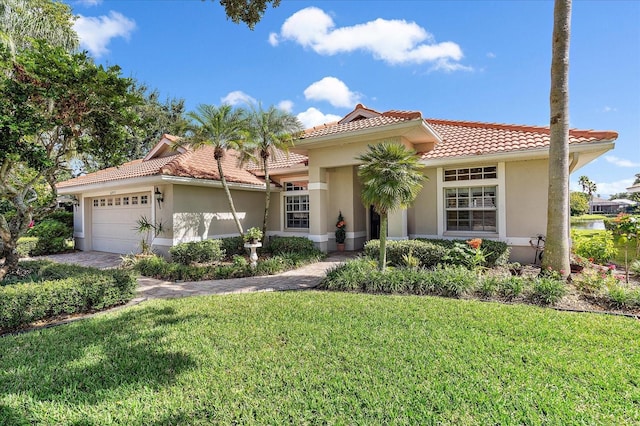 mediterranean / spanish-style house with a front lawn and a garage