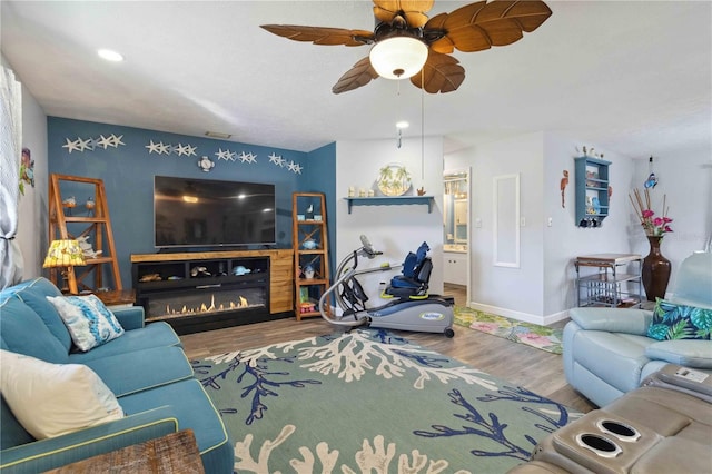 living room featuring hardwood / wood-style floors and ceiling fan