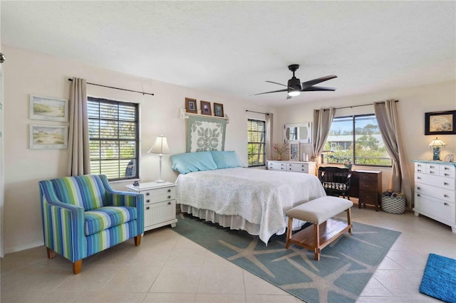 tiled bedroom featuring a textured ceiling and ceiling fan