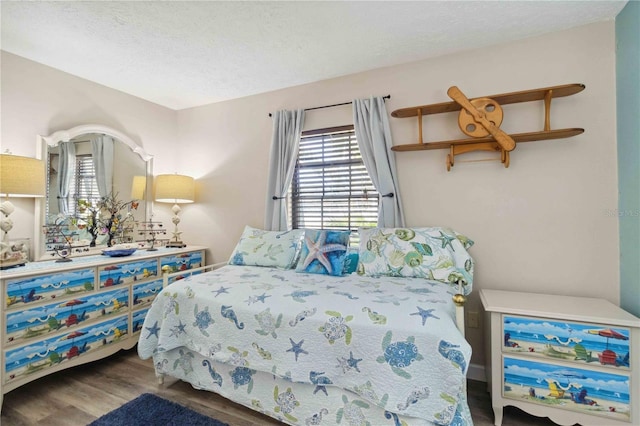 bedroom with hardwood / wood-style floors and a textured ceiling