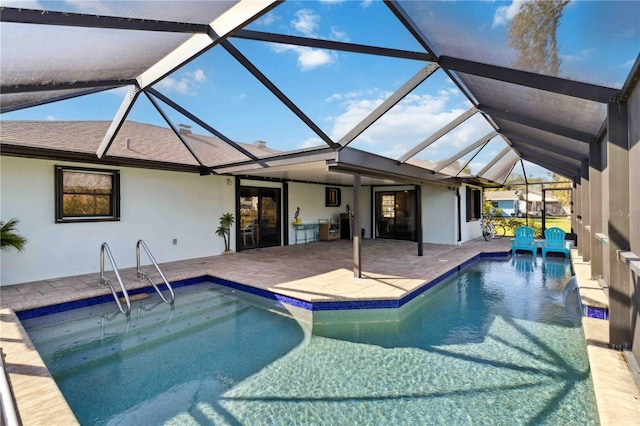 view of swimming pool featuring glass enclosure, a patio area, and pool water feature