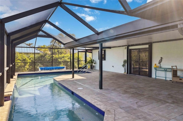 view of pool featuring pool water feature, a lanai, and a patio