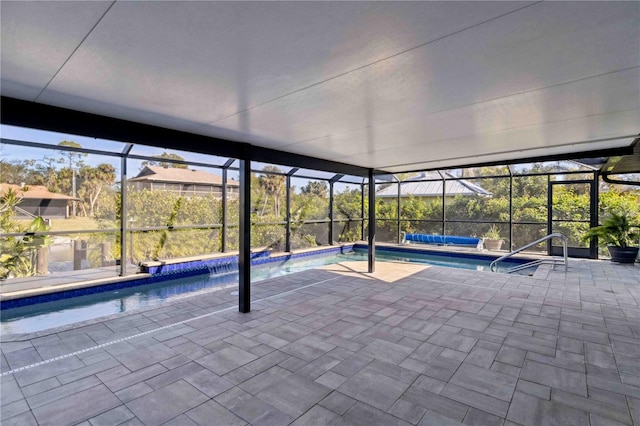 view of swimming pool featuring glass enclosure and a patio area