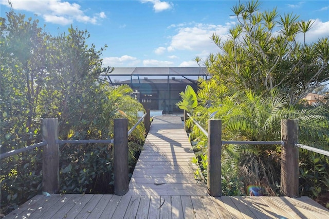 view of dock with a lanai