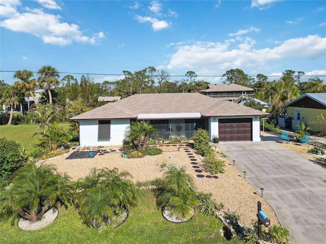 ranch-style home featuring a front yard and a garage