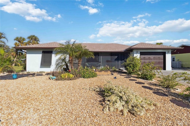 ranch-style home with a sunroom and a garage