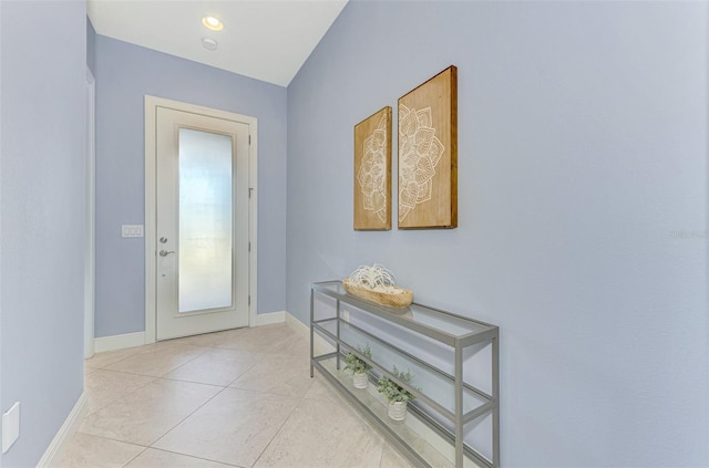 doorway to outside with light tile patterned floors