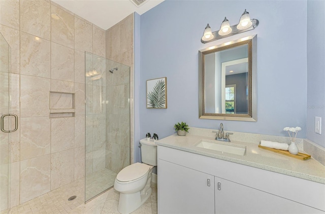 bathroom featuring tile patterned flooring, vanity, toilet, and an enclosed shower