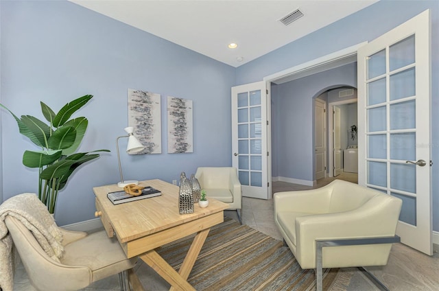 sitting room featuring tile patterned floors and french doors