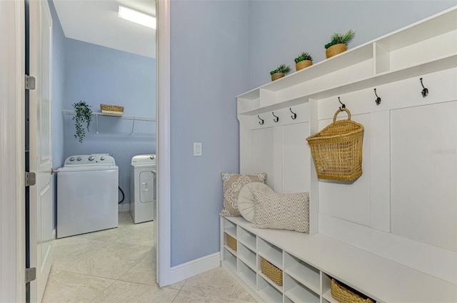 mudroom featuring washing machine and dryer and light tile patterned floors