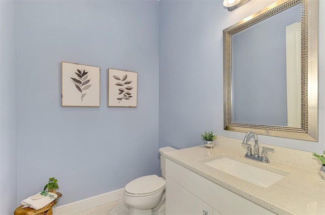 bathroom featuring tile patterned floors, vanity, and toilet