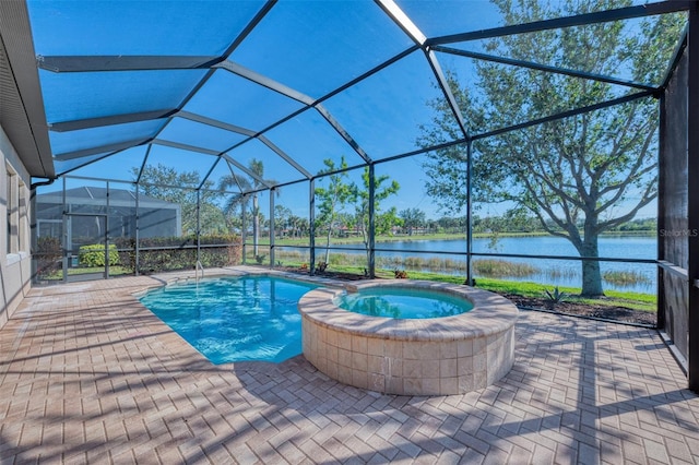 view of swimming pool featuring an in ground hot tub, a water view, and glass enclosure