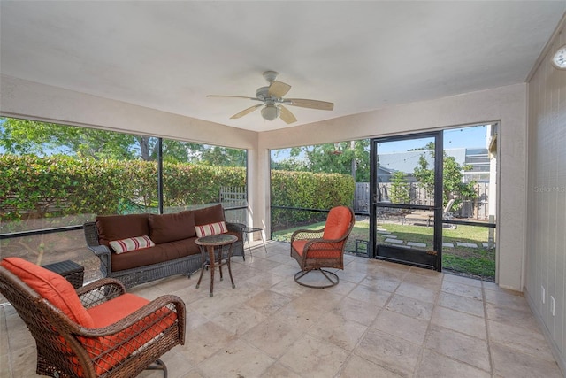 sunroom / solarium featuring ceiling fan