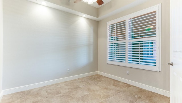 spare room featuring light tile patterned floors and ceiling fan