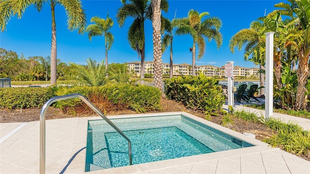 view of swimming pool with an in ground hot tub