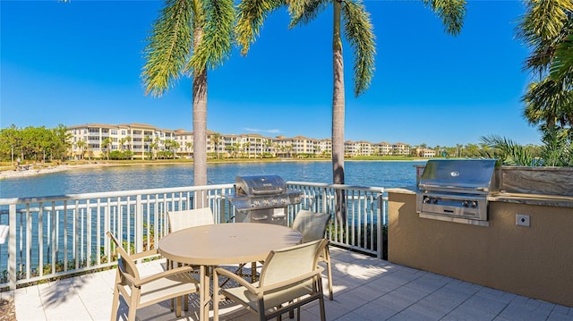 view of patio featuring a water view and grilling area