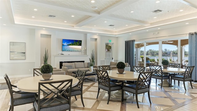 dining space with beamed ceiling, coffered ceiling, and light tile patterned flooring