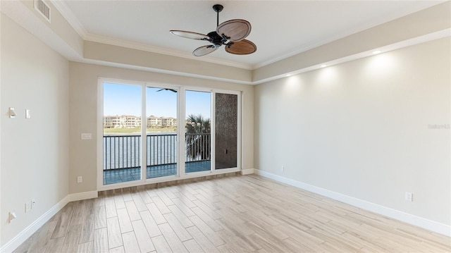 unfurnished room featuring ceiling fan, light wood-style flooring, crown molding, and baseboards