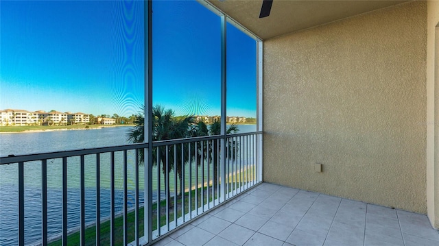 balcony with a water view and ceiling fan