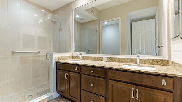 full bath featuring a stall shower and double vanity